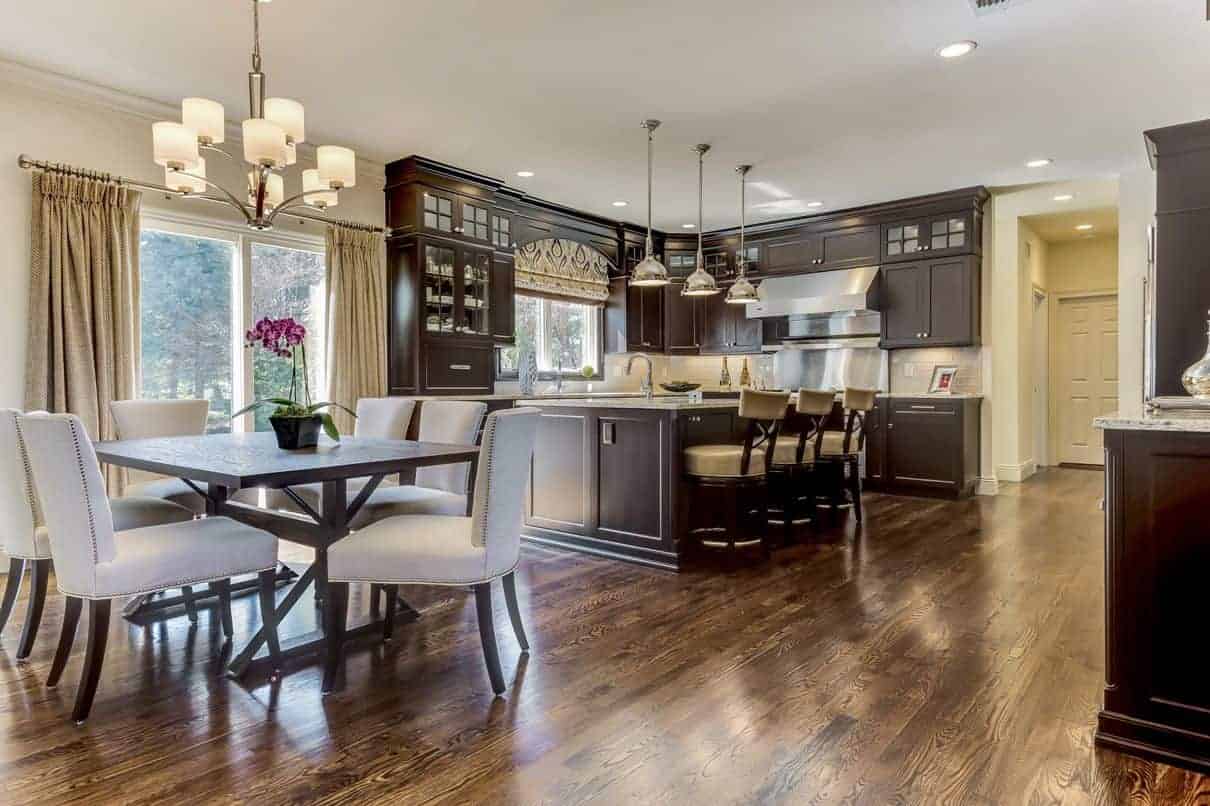 Beautiful dark wood kitchen cabinets add the richness and depth to this transitional kitchen in Woodbury, NY.