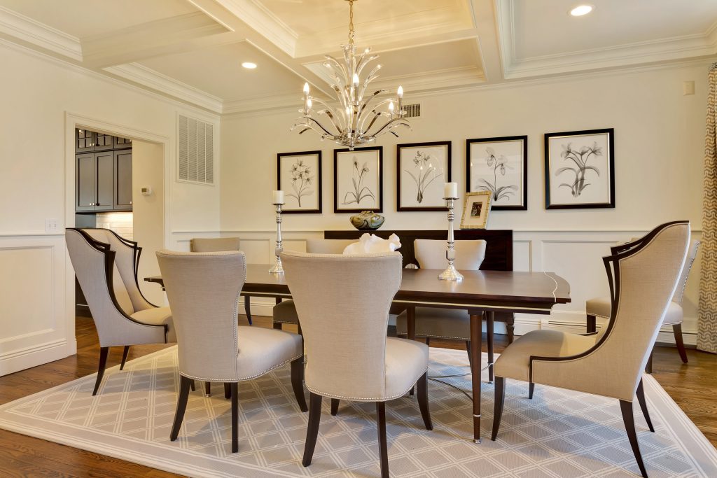 Custom box beam coffered ceiling and chair rail picture frame panel moulding added to emphasize the dining space.