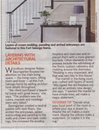 An article discussing layering with architectural details in home design, featuring crown molding and arched entryways. Includes a designer tip about focal points and a photo of a stylish room with an elegant gray wall, created by talented interior designers from Long Island, NY.