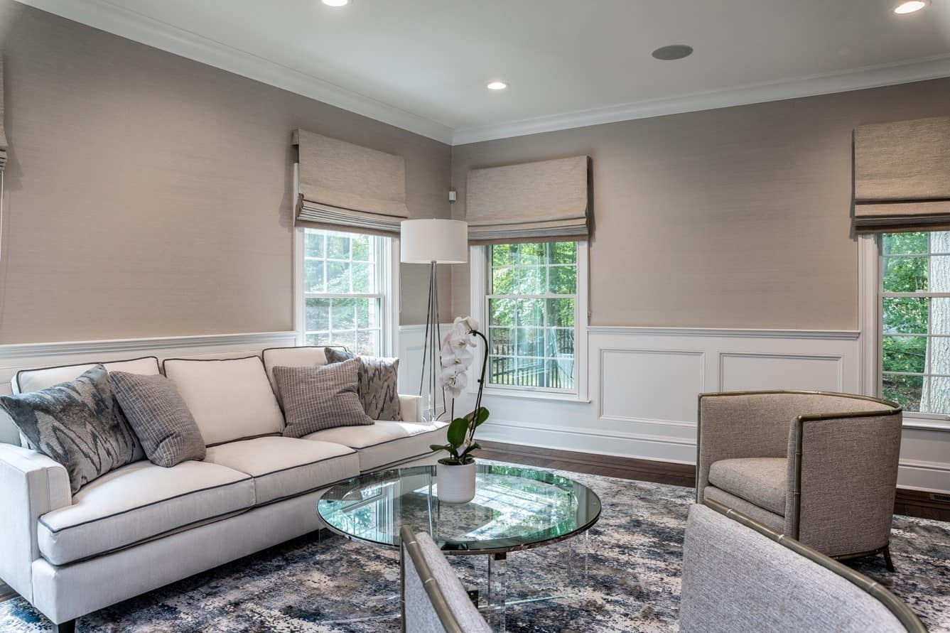 Completed Hamptons living room with neutral transitional palette, layered textiles, and classic lines