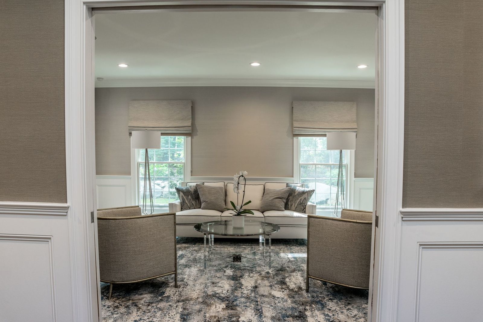Hamptons family room with built-in millwork, coffered ceiling, and custom fireplace mantel