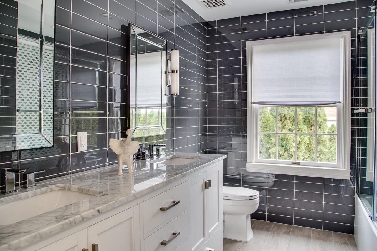 dark gray subway tiles in bathroom with white vanity