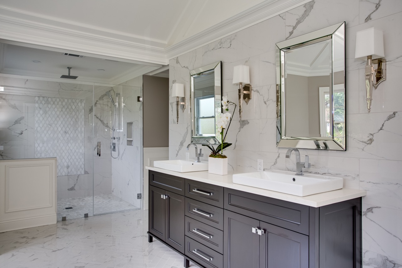 marble walls in bathroom with walk in glass shower