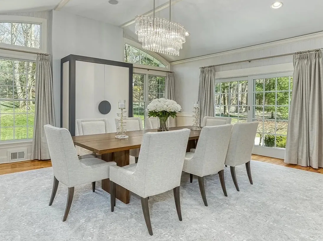 white dining room design with large windows in the Hamptons