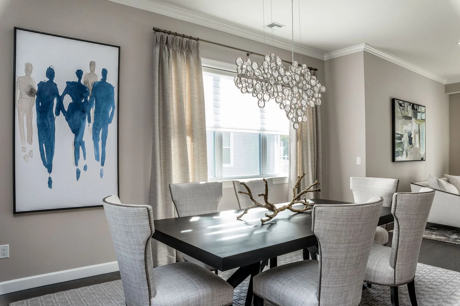 dark wood dining room table with interesting decor and gray cushioned high backed dining room chairs
