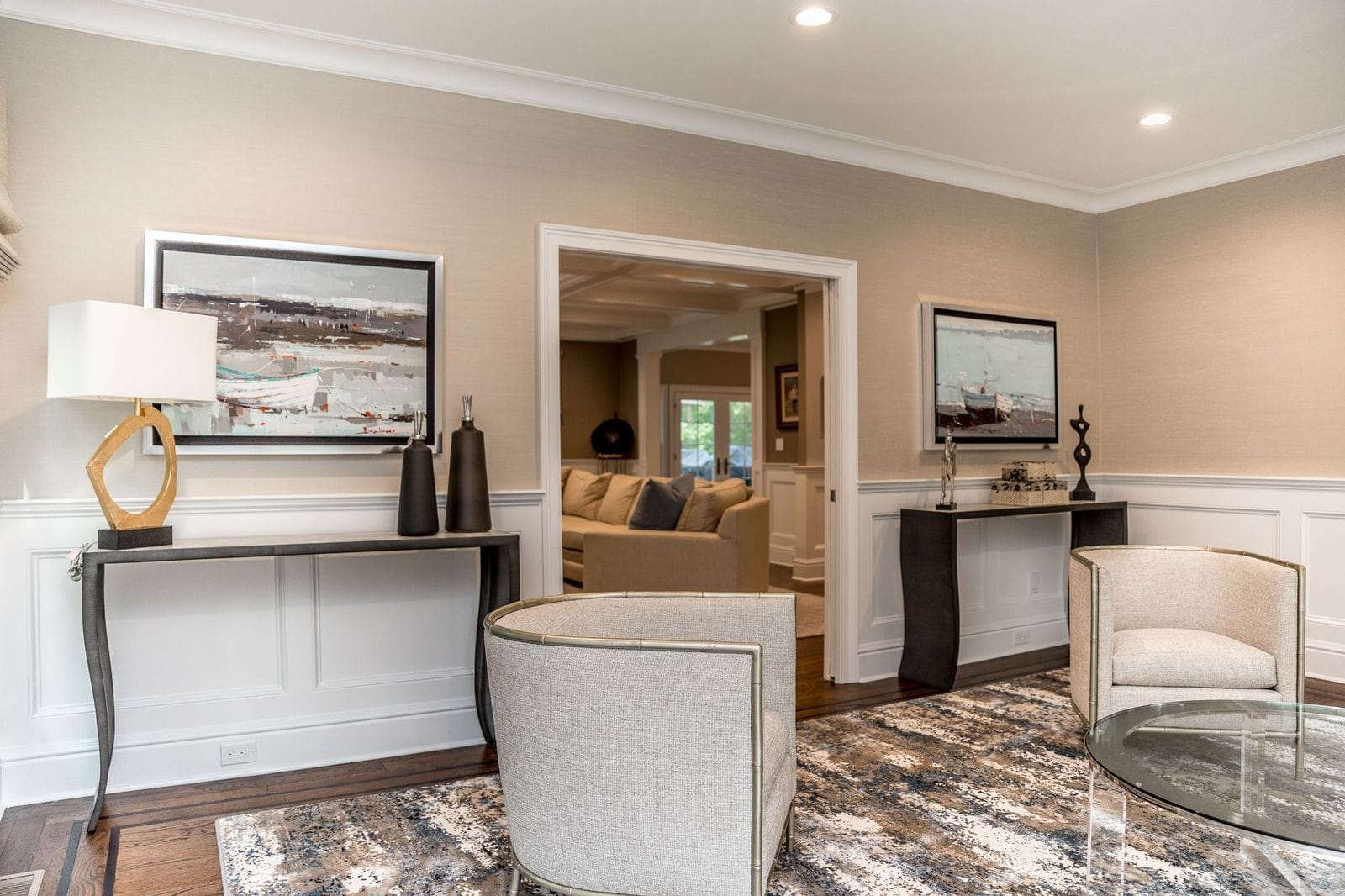 Marble-splattered Stark rug anchoring a Hamptons living room with neutral furnishings
